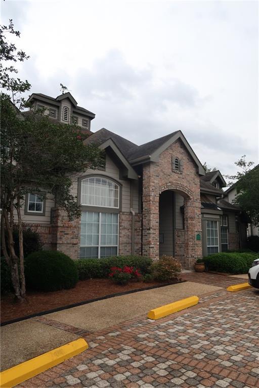350 Emerald Forest Blvd Unit 17103, Covington, LA 70433 - view of front of property featuring uncovered parking and brick siding