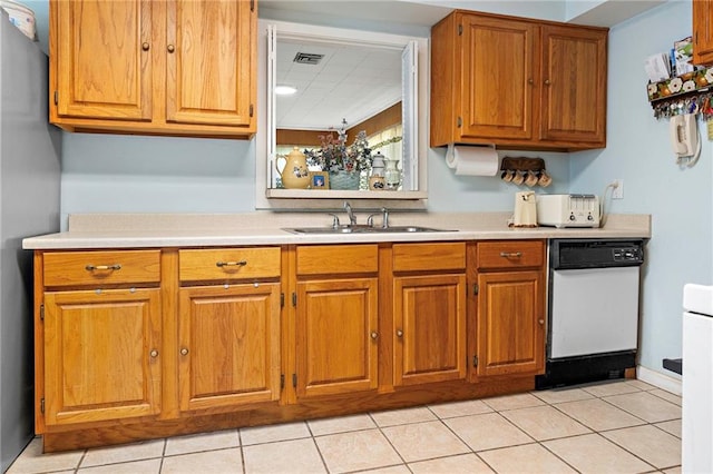 3513 Haring Rd, Metairie, LA 70006 - kitchen with light countertops, brown cabinets, light tile patterned floors, and dishwasher
