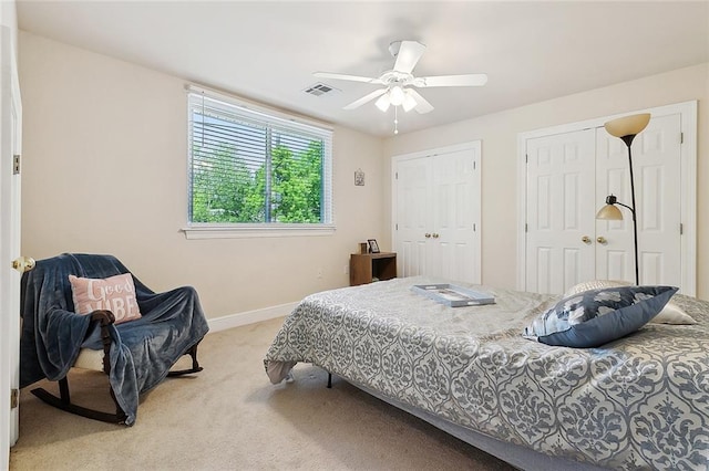 1424 Woodmere Dr, Mandeville, LA 70471 - bedroom featuring light colored carpet, multiple closets, baseboards, and ceiling fan