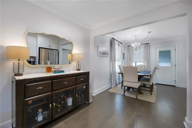 6208 Lafreniere St, Metairie, LA 70003 - dining area with a chandelier, ornamental molding, baseboards, and dark wood-style floors
