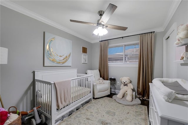 6208 Lafreniere St, Metairie, LA 70003 - bedroom featuring ornamental molding, a nursery area, wood finished floors, ceiling fan, and baseboards
