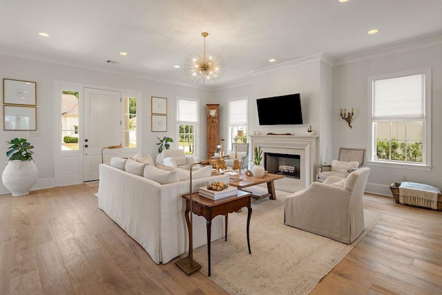 65 Hummingbird Rd, Covington, LA 70433 - living area featuring light wood-style flooring, crown molding, a chandelier, recessed lighting, and a fireplace