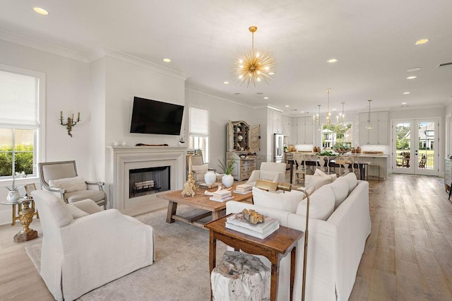 65 Hummingbird Rd, Covington, LA 70433 - living area with recessed lighting, a fireplace, a chandelier, light wood finished floors, and crown molding