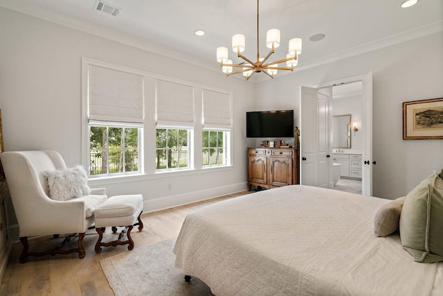 65 Hummingbird Rd, Covington, LA 70433 - bedroom with a chandelier, wood finished floors, ornamental molding, baseboards, and ensuite bath