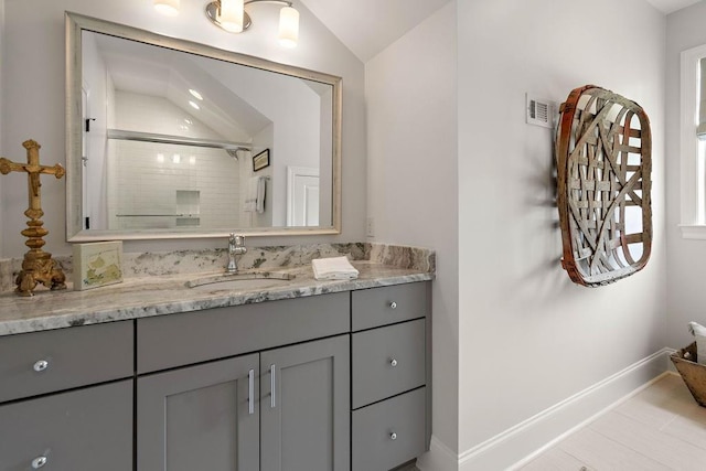 65 Hummingbird Rd, Covington, LA 70433 - bathroom featuring vanity, baseboards, vaulted ceiling, and an enclosed shower