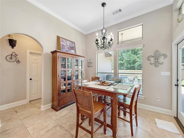 232 Old Mill Loop, Pearl River, LA 70452 - dining room featuring arched walkways, a chandelier, crown molding, a towering ceiling, and light tile patterned floors
