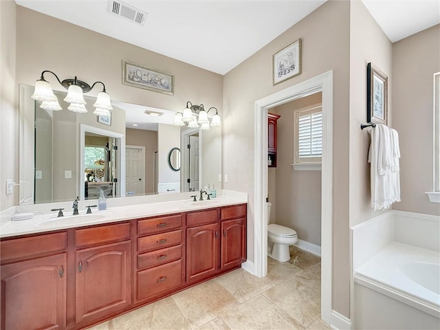 232 Old Mill Loop, Pearl River, LA 70452 - full bathroom featuring double vanity, a garden tub, toilet, and baseboards