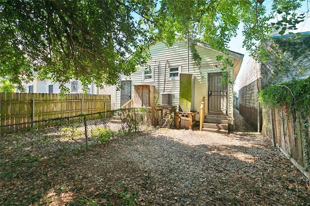 261315 N Prieur St, New Orleans, LA 70117 - back of property with a fenced backyard, entry steps, and central AC