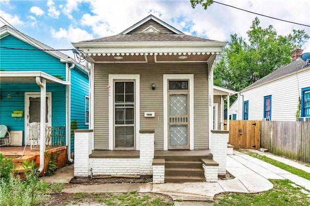 1606 N Broad St, New Orleans, LA 70119 - shotgun-style home with covered porch and roof with shingles