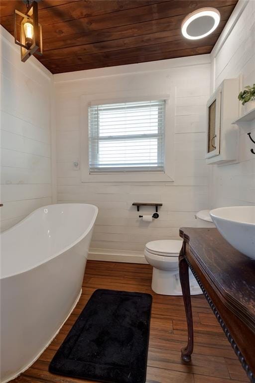 3113 Bayou View Pl, Slidell, LA 70458 - full bath with a freestanding tub, wood ceiling, wood finished floors, baseboards, and vanity