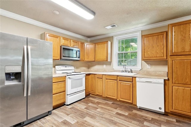 1928 Barbara Dr, Slidell, LA 70458 - kitchen with stainless steel appliances, a sink, ornamental molding, light countertops, and light wood-style flooring