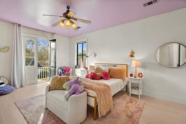 1322 S Jahncke Ave, Covington, LA 70434 - bedroom featuring access to exterior, a ceiling fan, wood finished floors, and baseboards