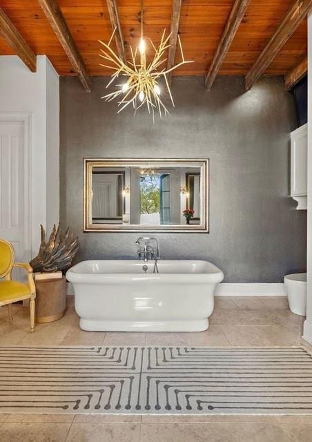1322 S Jahncke Ave, Covington, LA 70434 - full bathroom with wood ceiling with exposed beams, a freestanding bath, and tile patterned floors