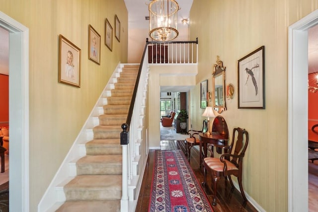214 Tchefuncte Dr, Covington, LA 70433 - stairway with a chandelier, a high ceiling, and baseboards
