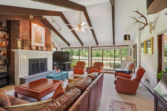 214 Tchefuncte Dr, Covington, LA 70433 - carpeted living room featuring beam ceiling, healthy amount of natural light, a ceiling fan, a tiled fireplace, and high vaulted ceiling