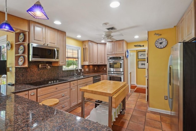 214 Tchefuncte Dr, Covington, LA 70433 - kitchen with stainless steel appliances, a sink, light tile patterned flooring, tasteful backsplash, and recessed lighting