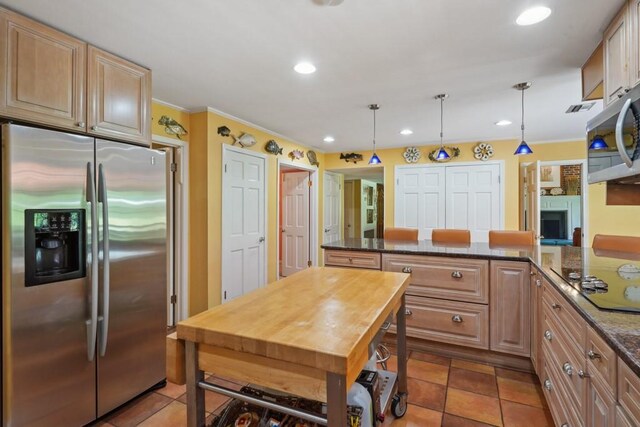 214 Tchefuncte Dr, Covington, LA 70433 - kitchen with stainless steel appliances, ornamental molding, recessed lighting, decorative light fixtures, and dark stone countertops