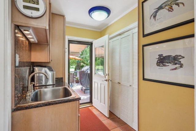 214 Tchefuncte Dr, Covington, LA 70433 - kitchen featuring a sink, dark countertops, crown molding, and light tile patterned flooring
