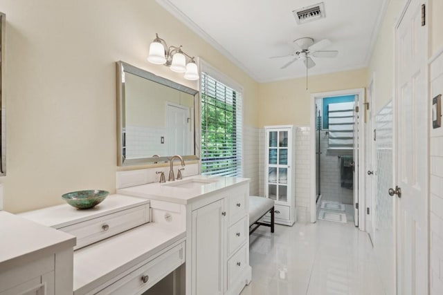 214 Tchefuncte Dr, Covington, LA 70433 - bathroom featuring ceiling fan, crown molding, vanity, tile patterned floors, and tile walls