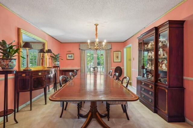 214 Tchefuncte Dr, Covington, LA 70433 - dining space featuring a chandelier, a textured ceiling, french doors, and crown molding