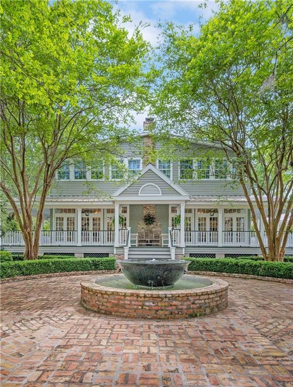 20263 Brunning Rd, Covington, LA 70435 - view of front of house with a porch, a chimney, and french doors