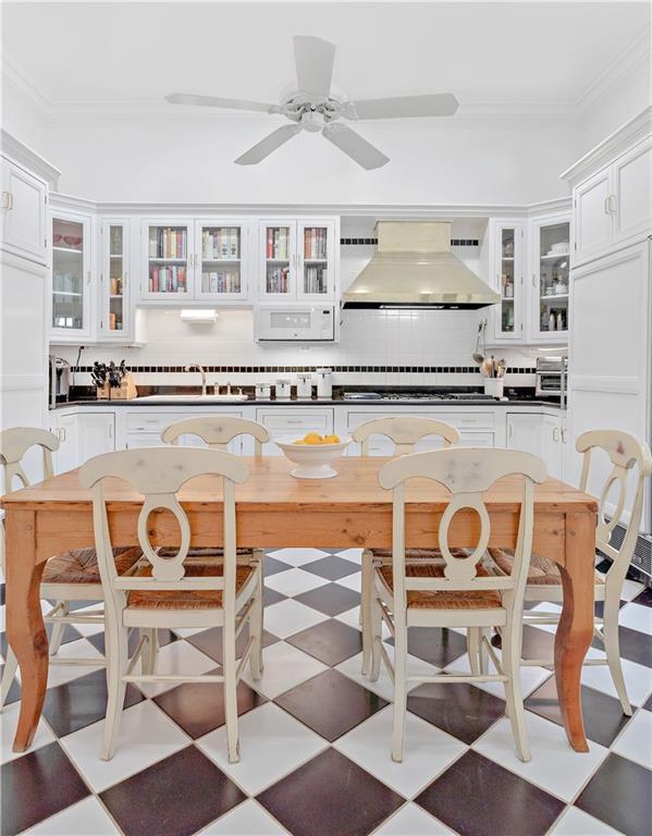 20263 Brunning Rd, Covington, LA 70435 - kitchen with premium range hood, a sink, tasteful backsplash, tile patterned floors, and ornamental molding