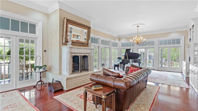 20263 Brunning Rd, Covington, LA 70435 - living room with healthy amount of natural light, dark wood finished floors, french doors, a chandelier, and crown molding
