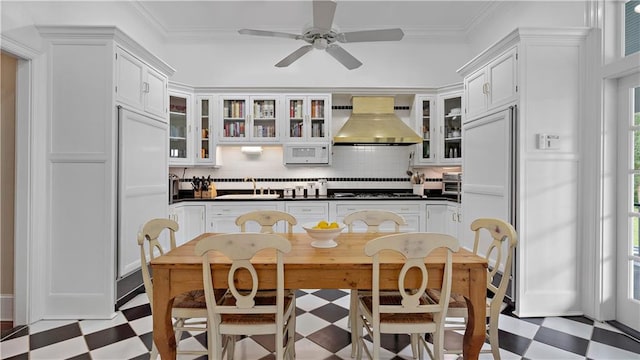 20263 Brunning Rd, Covington, LA 70435 - kitchen with exhaust hood, tile patterned floors, a sink, dark countertops, and crown molding