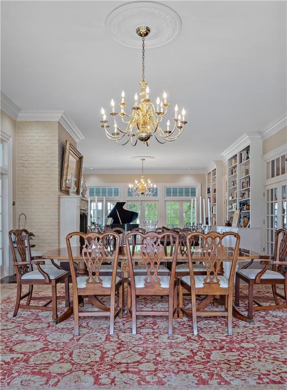 20263 Brunning Rd, Covington, LA 70435 - dining room featuring a chandelier, plenty of natural light, and ornamental molding