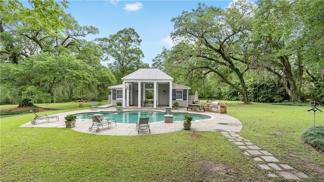 20263 Brunning Rd, Covington, LA 70435 - outdoor pool featuring an exterior structure, a patio area, an outdoor structure, and a yard