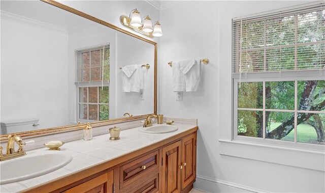 20263 Brunning Rd, Covington, LA 70435 - full bathroom featuring double vanity, ornamental molding, and toilet