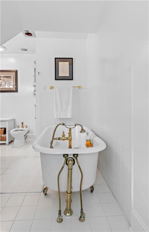 20263 Brunning Rd, Covington, LA 70435 - full bathroom with tile patterned flooring, a freestanding tub, and a bidet