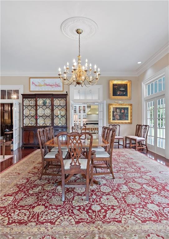 20263 Brunning Rd, Covington, LA 70435 - dining area with crown molding, a chandelier, and wood finished floors