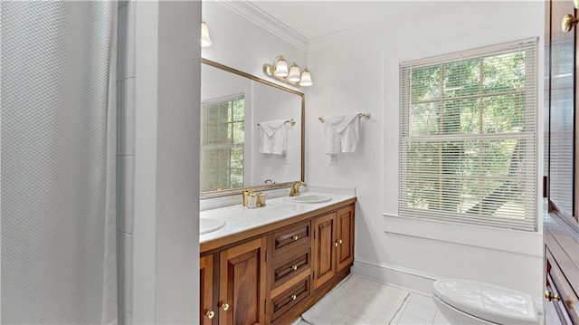 20263 Brunning Rd, Covington, LA 70435 - full bath featuring double vanity, crown molding, toilet, tile patterned flooring, and baseboards