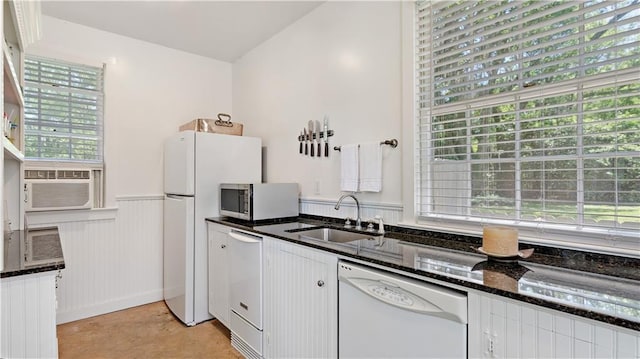 20263 Brunning Rd, Covington, LA 70435 - kitchen featuring white dishwasher, stainless steel microwave, a sink, healthy amount of natural light, and a wainscoted wall
