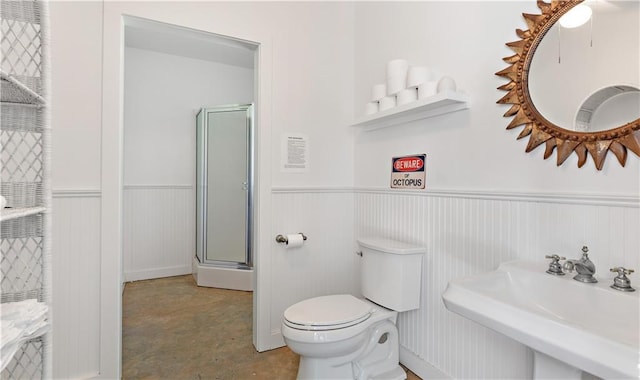 20263 Brunning Rd, Covington, LA 70435 - full bathroom featuring wainscoting, an enclosed shower, toilet, and a sink