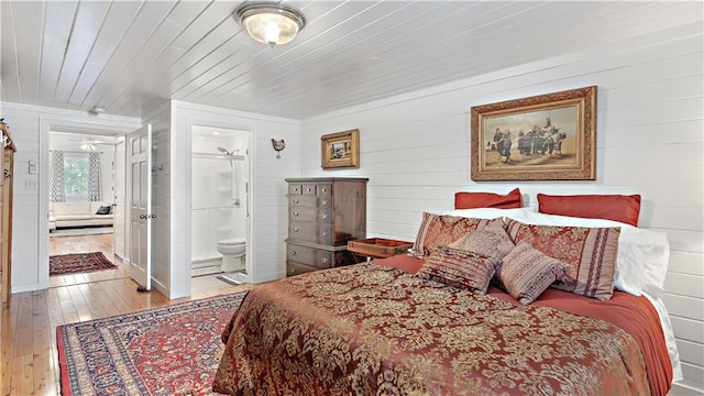 20263 Brunning Rd, Covington, LA 70435 - bedroom featuring hardwood / wood-style flooring, ensuite bath, wood walls, and wooden ceiling