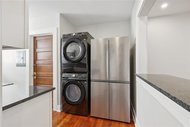 1530 Bordeaux St Unit C, New Orleans, LA 70115 - laundry room with estacked washer and dryer, dark wood finished floors, electric panel, and recessed lighting