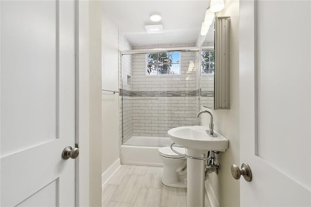 1530 Bordeaux St Unit C, New Orleans, LA 70115 - full bathroom with shower / bath combination with glass door, toilet, baseboards, and a sink
