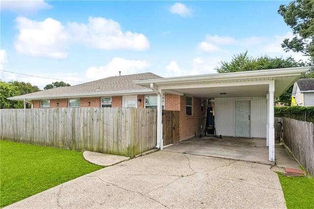 620 Maryland Ave, Metairie, LA 70003 - view of front of house featuring brick siding, concrete driveway, and a carport