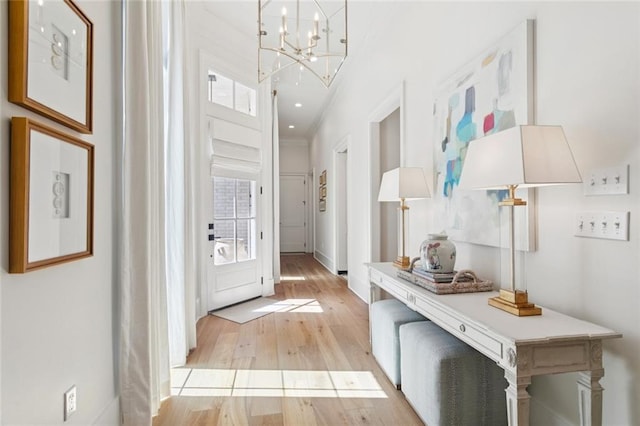 516 N Corniche Du Lac, Covington, LA 70433 - foyer with light wood-style floors, a chandelier, and baseboards