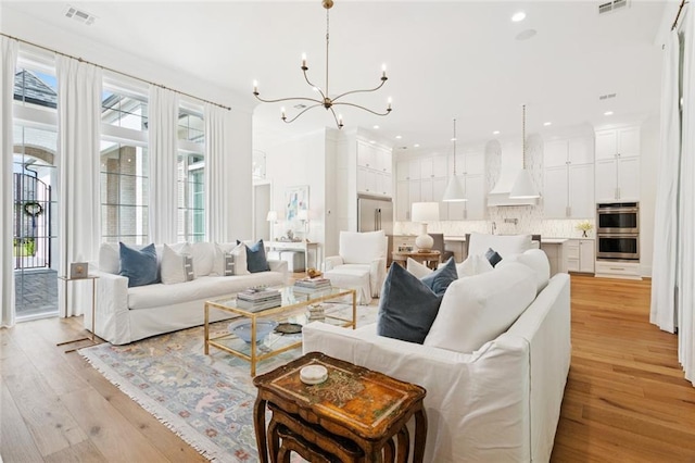 516 N Corniche Du Lac, Covington, LA 70433 - living room featuring a chandelier, light wood-style flooring, and recessed lighting