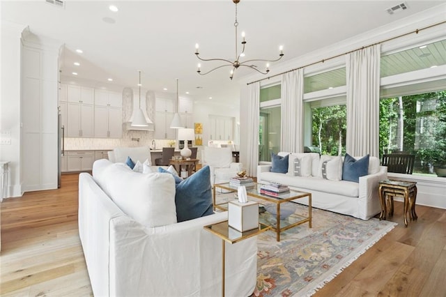 516 N Corniche Du Lac, Covington, LA 70433 - living area featuring a chandelier, light wood-style floors, recessed lighting, and ornamental molding