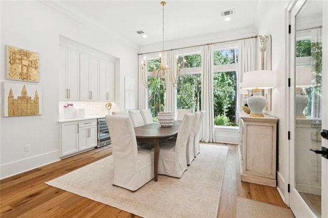 516 N Corniche Du Lac, Covington, LA 70433 - dining space with light wood-style floors, crown molding, baseboards, a chandelier, and recessed lighting