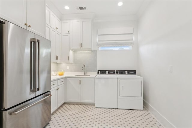 516 N Corniche Du Lac, Covington, LA 70433 - laundry area featuring a sink, separate washer and dryer, light floors, recessed lighting, and baseboards