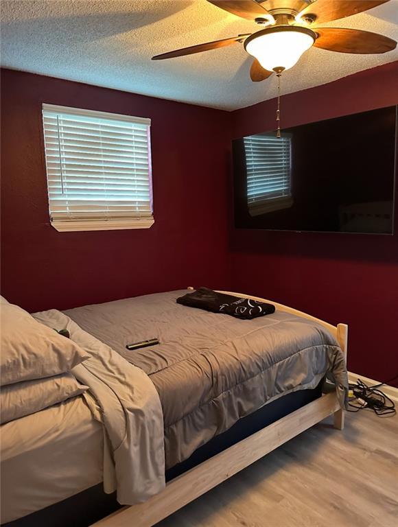 4405 Cartier Ave, New Orleans, LA 70122 - bedroom featuring wood finished floors and ceiling fan