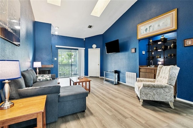 54 Avant Garde Cir Unit 54, Kenner, LA 70065 - living area with wood finished floors, a skylight, high vaulted ceiling, and baseboards
