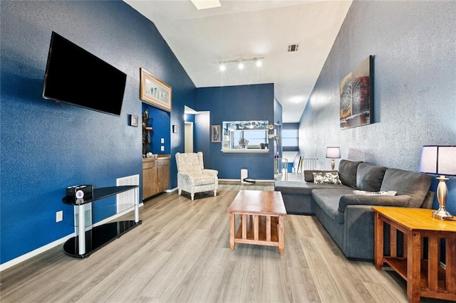 54 Avant Garde Cir Unit 54, Kenner, LA 70065 - living area with rail lighting, wood finished floors, and lofted ceiling