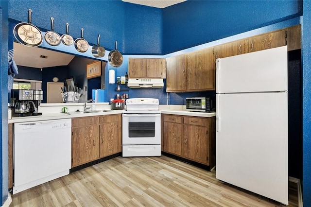 54 Avant Garde Cir Unit 54, Kenner, LA 70065 - kitchen with white appliances, under cabinet range hood, a sink, and light countertops