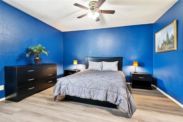 54 Avant Garde Cir Unit 54, Kenner, LA 70065 - bedroom featuring wood finished floors, baseboards, a ceiling fan, and a textured ceiling